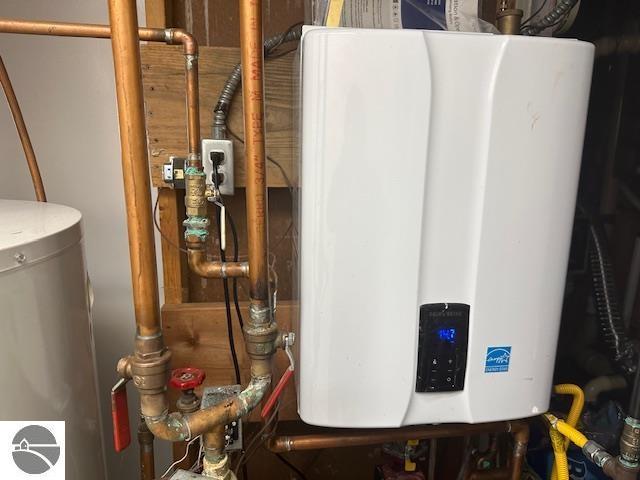 1094 Fairway Dr, Lake Isabella, MI 48893 - utility room with tankless water heater and gas water heater