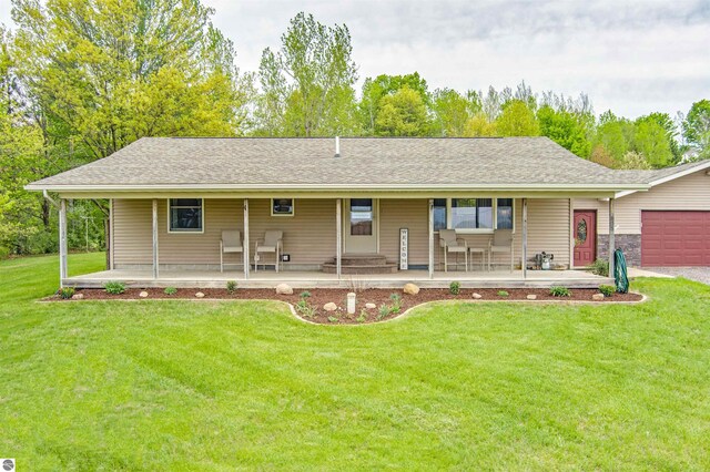 605 E M-55, West Branch, MI 48661 - view of front facade featuring a porch, a front yard, and a garage