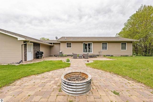 605 E M-55, West Branch, MI 48661 - back of house featuring a fire pit, a patio area, a yard, and entry steps