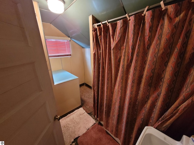 415 Elwell St, Alma, MI 48801 - bathroom featuring lofted ceiling and curtained shower
