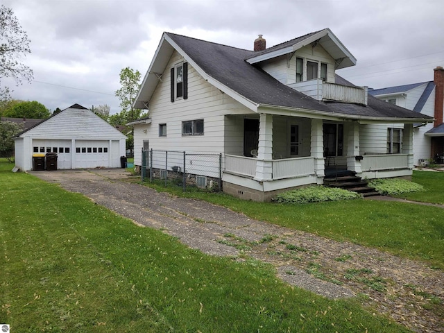 415 Elwell St, Alma, MI 48801 - view of front of property with covered porch, a garage, an outbuilding, a chimney, and a front yard