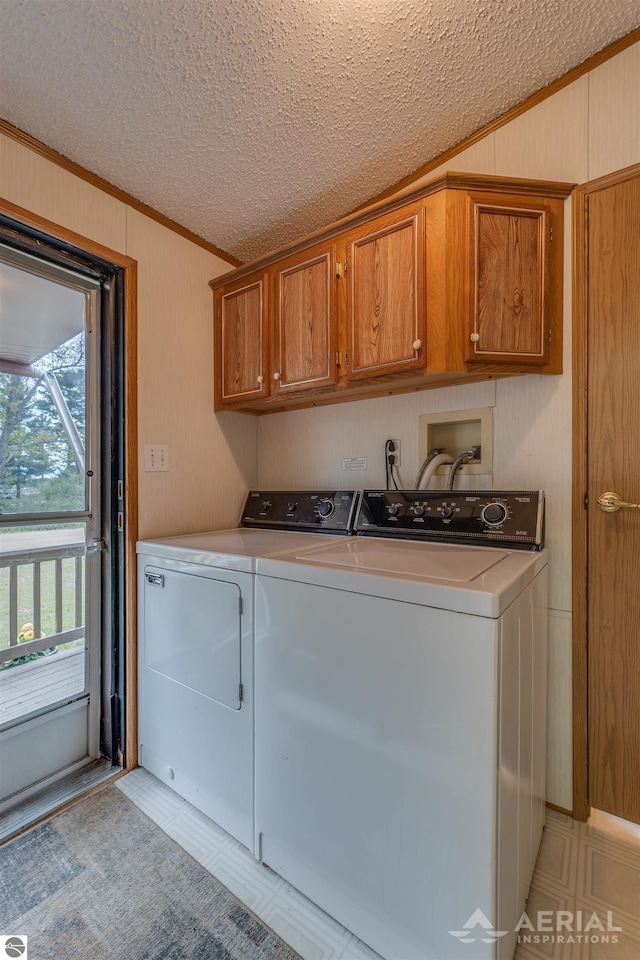 1929 Mohawk Trl, West Branch, MI 48661 - washroom with washer and dryer, cabinet space, crown molding, wooden walls, and a textured ceiling