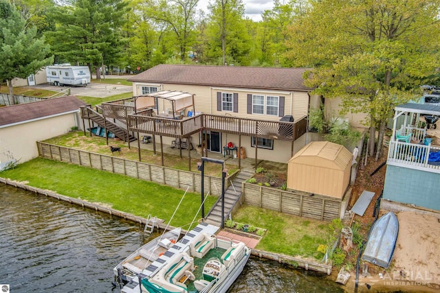 1929 Mohawk Trl, West Branch, MI 48661 - back of house featuring stairs, a deck with water view, and a view of trees