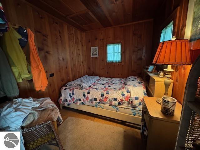951 Lake Dr, Harrison, MI 48625 - bedroom featuring wooden walls and wood ceiling