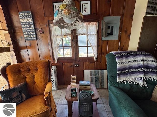 951 Lake Dr, Harrison, MI 48625 - sitting room with wooden walls, electric panel, and light tile patterned floors