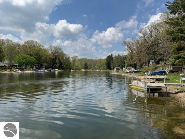 951 Lake Dr, Harrison, MI 48625 - dock featuring a water view and a wooded view