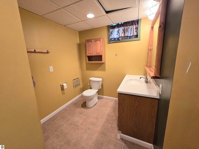 1470 N Al Moses Rd, Lake City, MI 49651 - bathroom with toilet, vanity, tile patterned floors, a paneled ceiling, and baseboards