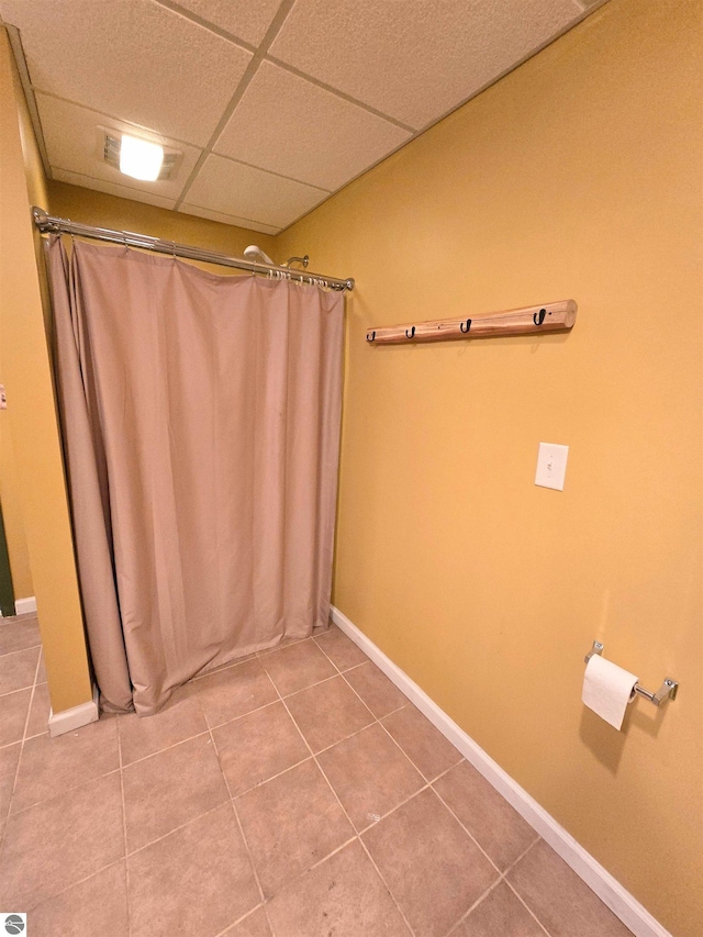 1470 N Al Moses Rd, Lake City, MI 49651 - bathroom featuring a drop ceiling, tile patterned floors, baseboards, and a shower with curtain
