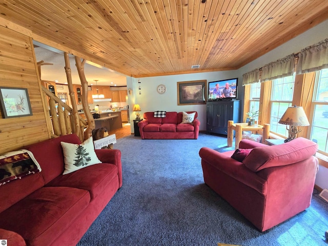1470 N Al Moses Rd, Lake City, MI 49651 - carpeted living area with wood ceiling, stairway, and wood walls