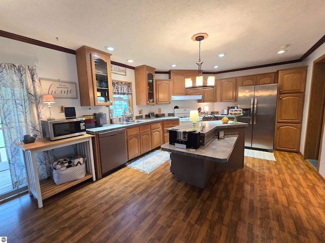 1470 N Al Moses Rd, Lake City, MI 49651 - kitchen featuring appliances with stainless steel finishes, a kitchen island, dark wood-style flooring, ornamental molding, and under cabinet range hood