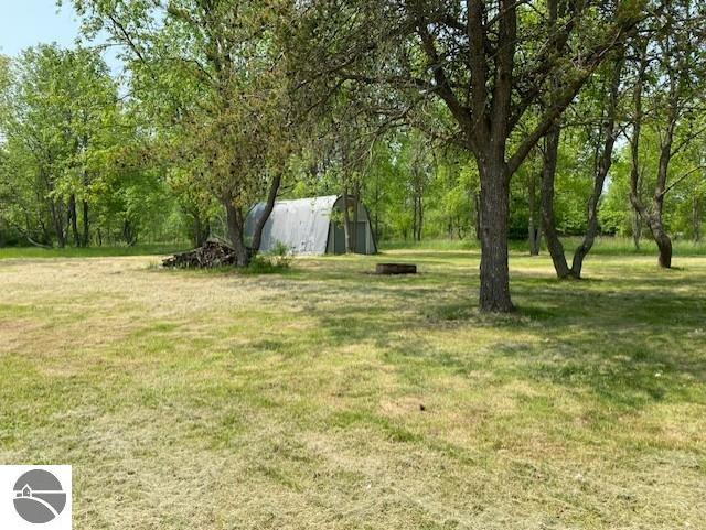10559 Rosted Rd, Lake City, MI 49651 - view of green lawn featuring an outdoor structure