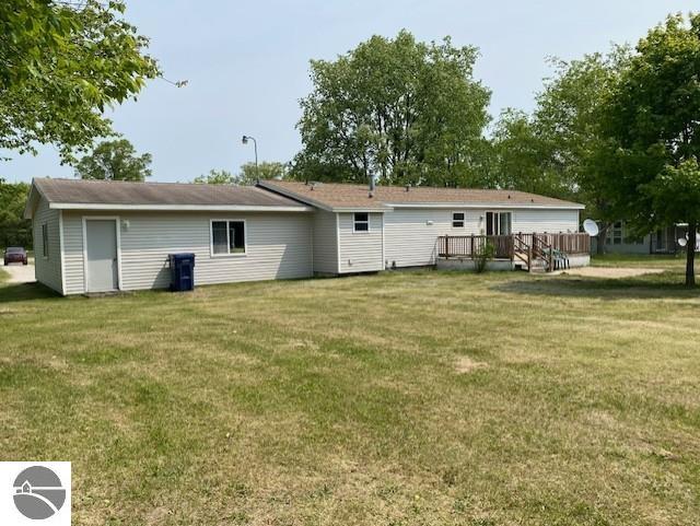 10559 Rosted Rd, Lake City, MI 49651 - rear view of house featuring a wooden deck and a yard