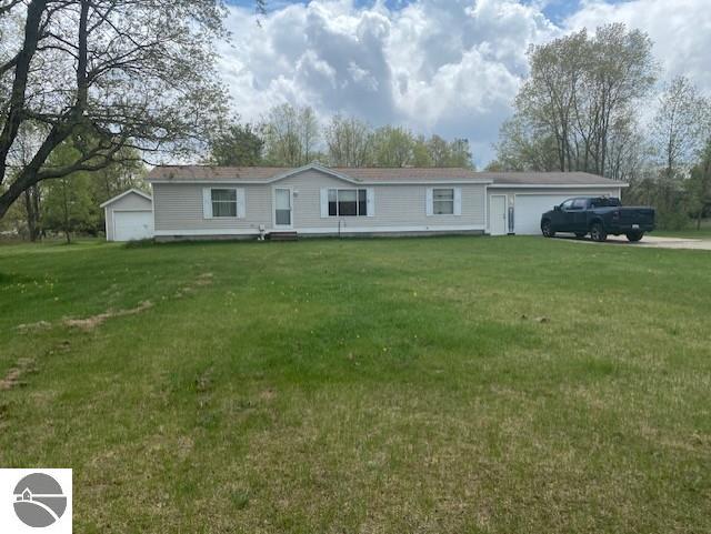 10559 Rosted Rd, Lake City, MI 49651 - view of front of house with a front yard and a detached garage
