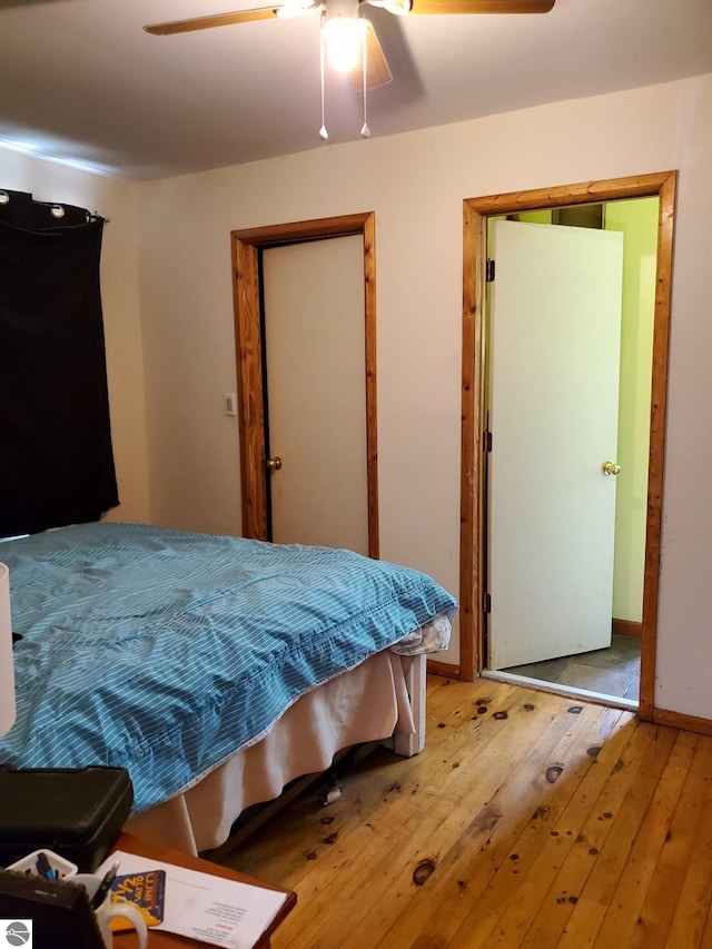 1148 Horseshoe Dr, Alger, MI 48610 - bedroom with hardwood / wood-style flooring, a ceiling fan, and baseboards