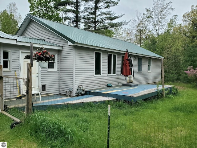 1148 Horseshoe Dr, Alger, MI 48610 - rear view of property with a deck, metal roof, and a lawn