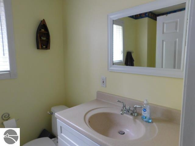 12149 Cabin Ln, Rapid City, MI 49676 - bathroom featuring vanity and toilet