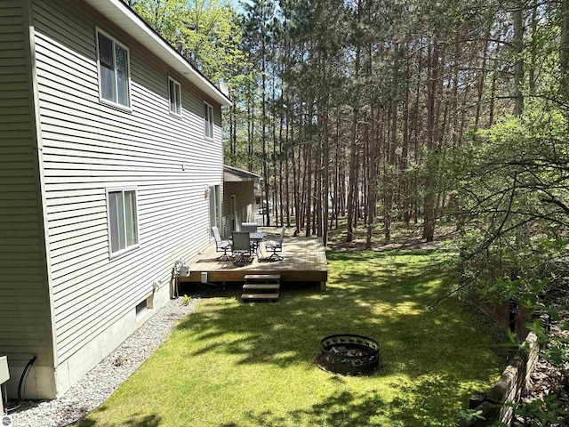 12149 Cabin Ln, Rapid City, MI 49676 - view of green lawn with a wooden deck