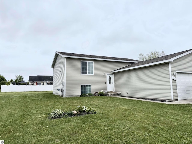 2442 Joseph Dr, Mount Pleasant, MI 48858 - back of house featuring a garage and entry steps
