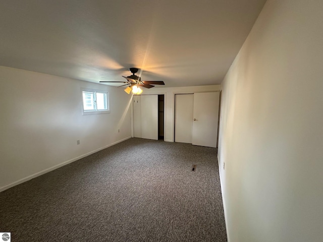 1007 Park St, Mount Pleasant, MI 48858 - unfurnished bedroom with two closets, carpet flooring, ceiling fan, and baseboards