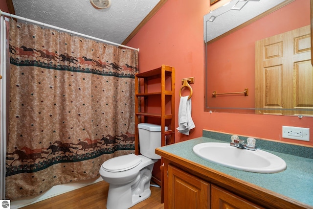 11567 Lake Valley Rd, Kalkaska, MI 49646 - bathroom featuring wood finished floors, toilet, vanity, crown molding, and a textured ceiling