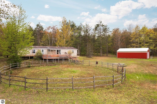11567 Lake Valley Rd, Kalkaska, MI 49646 - view of yard with a wooden deck, a view of trees, an outbuilding, a pole building, and a view of rural / pastoral area