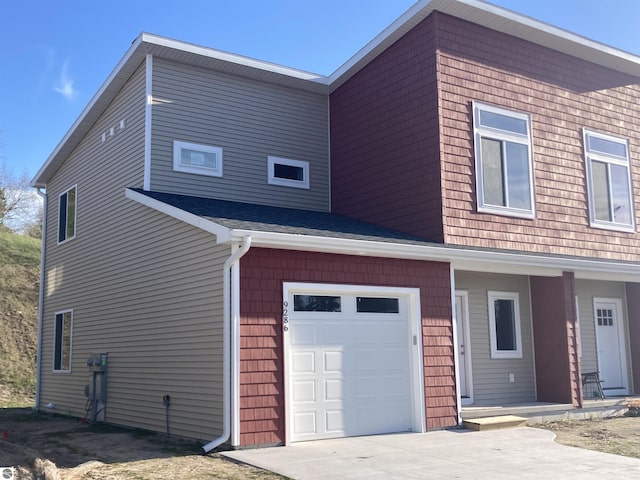 9286 S Flaska Dr Unit 12, Cedar, MI 49621 - view of side of home with an attached garage, a porch, and driveway