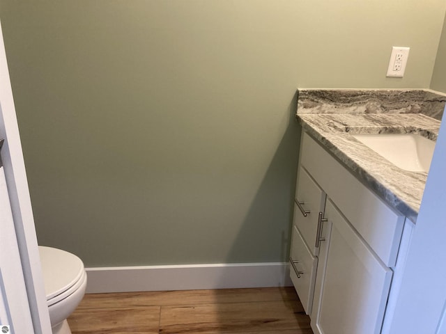 9296 S Flaska Dr Unit 14, Cedar, MI 49621 - bathroom featuring vanity, wood finished floors, toilet, and baseboards
