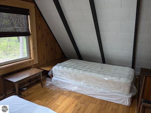 7117 Grove, South Branch, MI 48761 - bedroom featuring wood finished floors, vaulted ceiling, and wooden walls