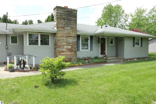 505 Eaton St, Breckenridge, MI 48615 - view of front of home with a chimney, a front lawn, and a shingled roof
