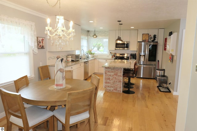 505 Eaton St, Breckenridge, MI 48615 - dining space featuring light wood-type flooring, a chandelier, crown molding, and recessed lighting