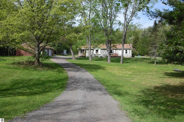 1137 Stoney Ridge Rd, West Branch, MI 48661 - view of front of property featuring an outbuilding, a front lawn, and driveway