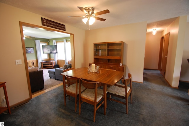 1137 Stoney Ridge Rd, West Branch, MI 48661 - carpeted dining area with a ceiling fan and baseboards