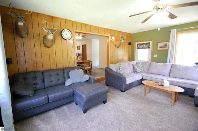 1137 Stoney Ridge Rd, West Branch, MI 48661 - living room with wooden walls, carpet flooring, and a ceiling fan