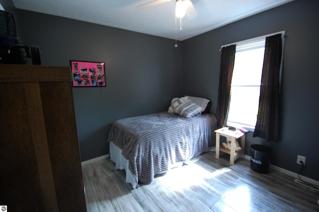 1137 Stoney Ridge Rd, West Branch, MI 48661 - bedroom featuring wood finished floors, baseboards, and ceiling fan