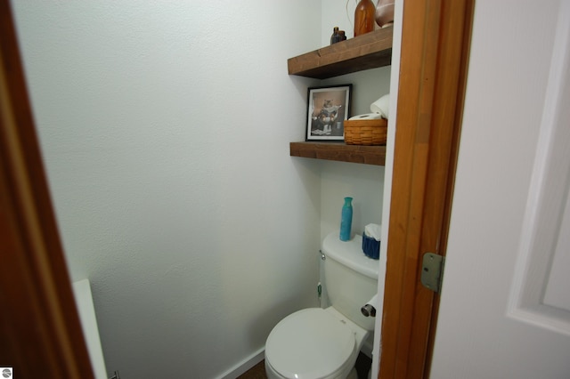 1137 Stoney Ridge Rd, West Branch, MI 48661 - bathroom with toilet and baseboards