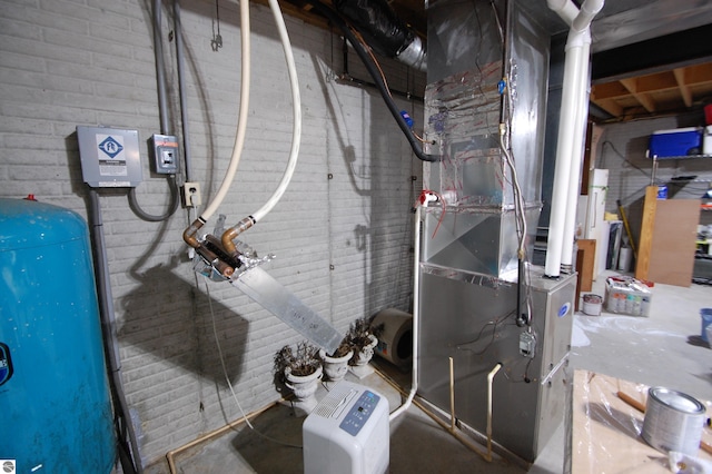 1137 Stoney Ridge Rd, West Branch, MI 48661 - utility room with heating unit