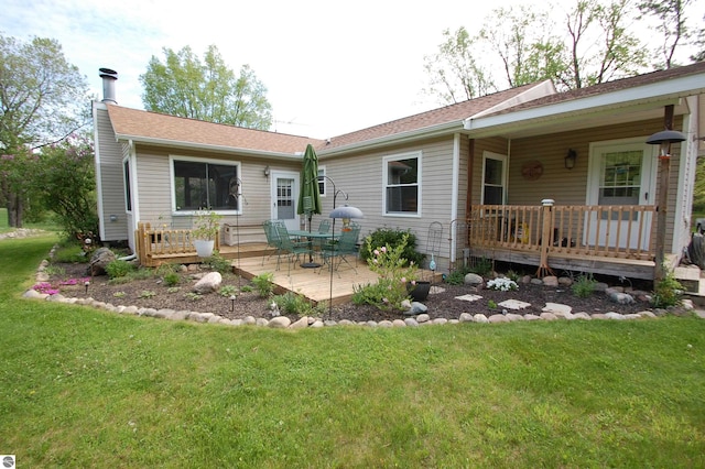 1137 Stoney Ridge Rd, West Branch, MI 48661 - view of front facade with a front yard, a deck, a patio area, and a shingled roof