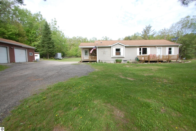 1137 Stoney Ridge Rd, West Branch, MI 48661 - view of front of house featuring a wooden deck, a front yard, a detached garage, and an outdoor structure