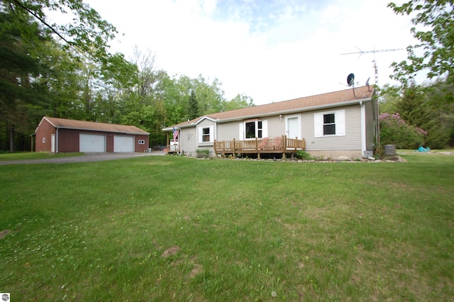 1137 Stoney Ridge Rd, West Branch, MI 48661 - view of front of house with a garage, an outdoor structure, a wooden deck, and a front lawn