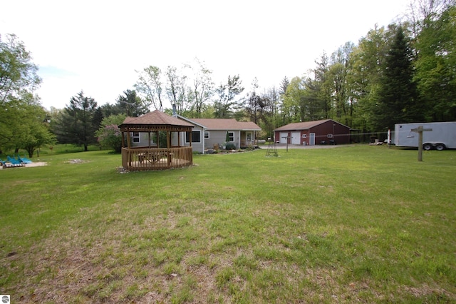 1137 Stoney Ridge Rd, West Branch, MI 48661 - view of grassy yard with a gazebo, a detached garage, an outdoor structure, and view of wooded area