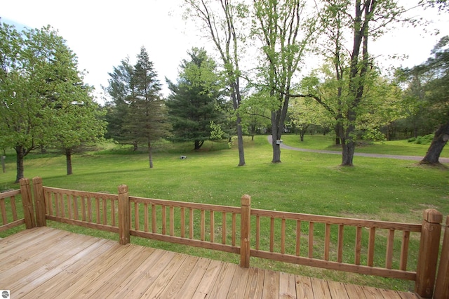 1137 Stoney Ridge Rd, West Branch, MI 48661 - wooden terrace featuring a lawn and view of wooded area