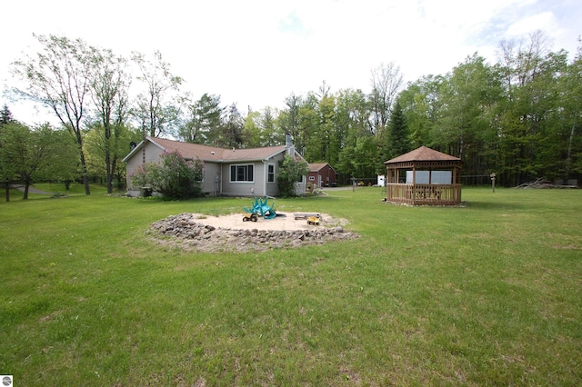 1137 Stoney Ridge Rd, West Branch, MI 48661 - view of grassy yard featuring a gazebo and an outdoor fire pit
