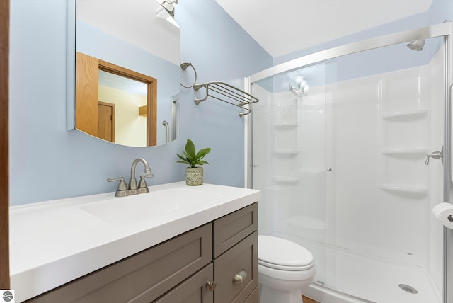 2683 Green Meadows Dr Unit 10, Traverse City, MI 49685 - bathroom with a shower stall, vanity, and toilet