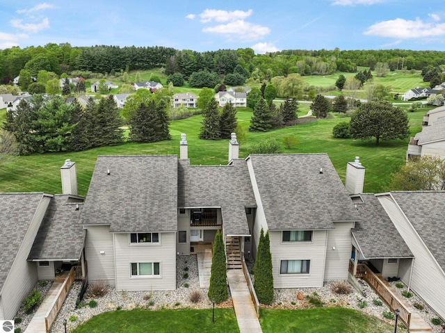 2683 Green Meadows Dr Unit 10, Traverse City, MI 49685 - view of front of house with stairs, a chimney, roof with shingles, and a front lawn