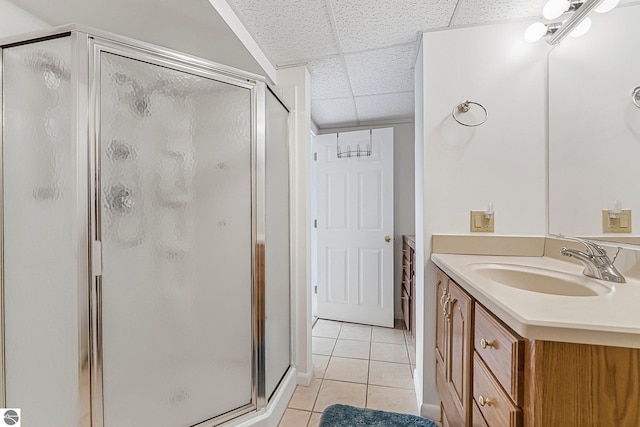 2683 Green Meadows Dr Unit 10, Traverse City, MI 49685 - bathroom featuring tile patterned floors, vanity, a shower stall, and a drop ceiling
