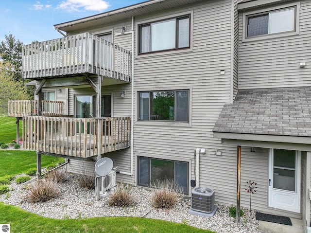 2683 Green Meadows Dr Unit 10, Traverse City, MI 49685 - back of property with central AC, a balcony, and a deck