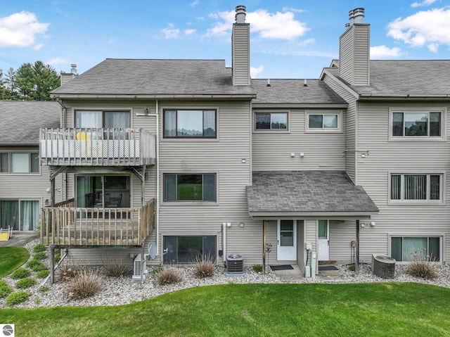 2683 Green Meadows Dr Unit 10, Traverse City, MI 49685 - rear view of house with a lawn, central AC, a balcony, and a chimney