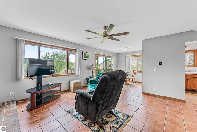 2683 Green Meadows Dr Unit 10, Traverse City, MI 49685 - living area with a ceiling fan, light tile patterned flooring, and baseboards