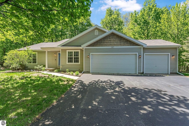 4667 Arbor Latch, Traverse City, MI 49685 - ranch-style home with asphalt driveway, a garage, and a front yard