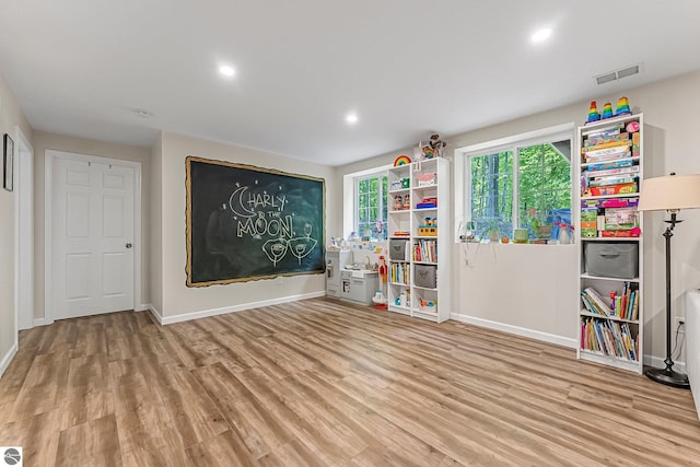 4667 Arbor Latch, Traverse City, MI 49685 - unfurnished room with baseboards, wood finished floors, plenty of natural light, and recessed lighting
